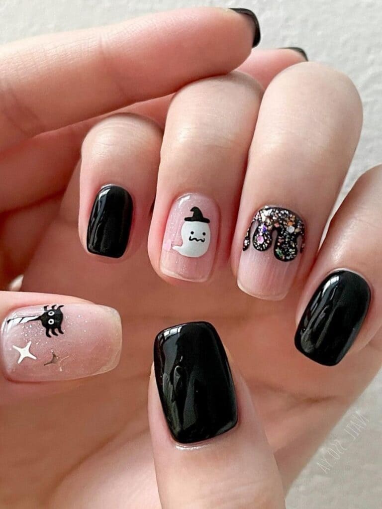 Short black nails with glitter, a ghost, and a spider