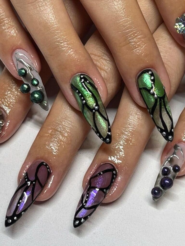 Metallic green and purple nails with Gothic butterfly design