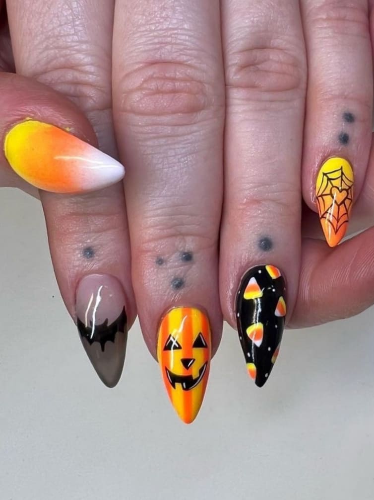 Short, stiletto-shaped candy corn nails