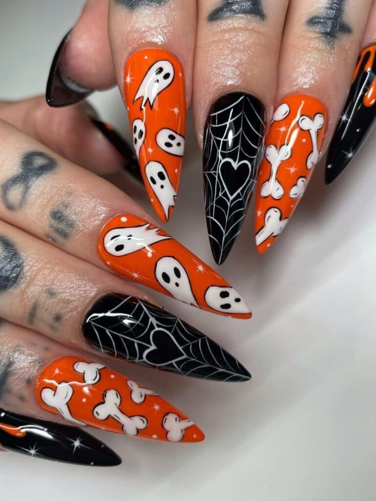 Long, stiletto-shaped Halloween acrylic nails in orange and black