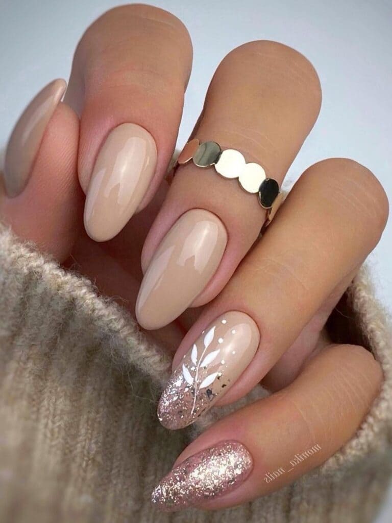 Beige nails with glitter and leaf designs