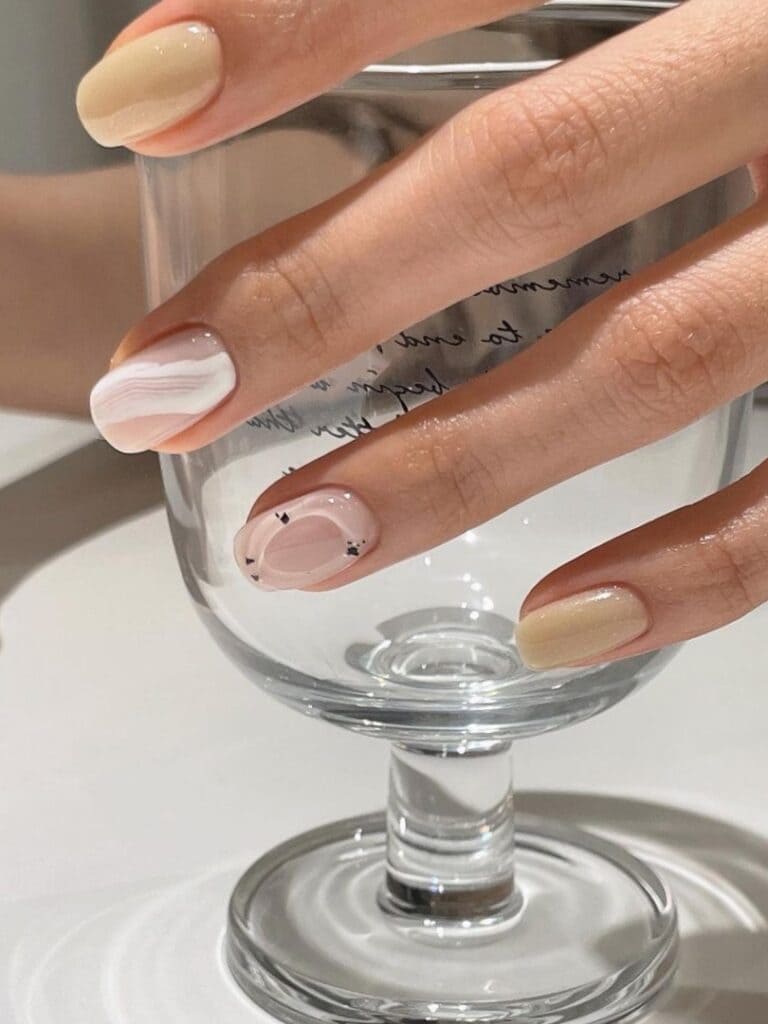Milky white and beige short nails with 3D jelly embellishment