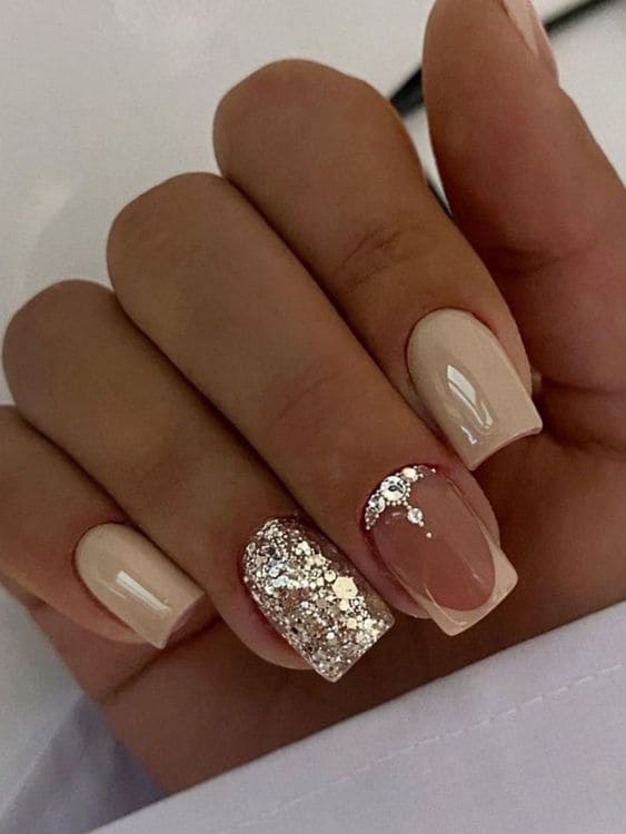 Glitter, gems, and short beige nail designs