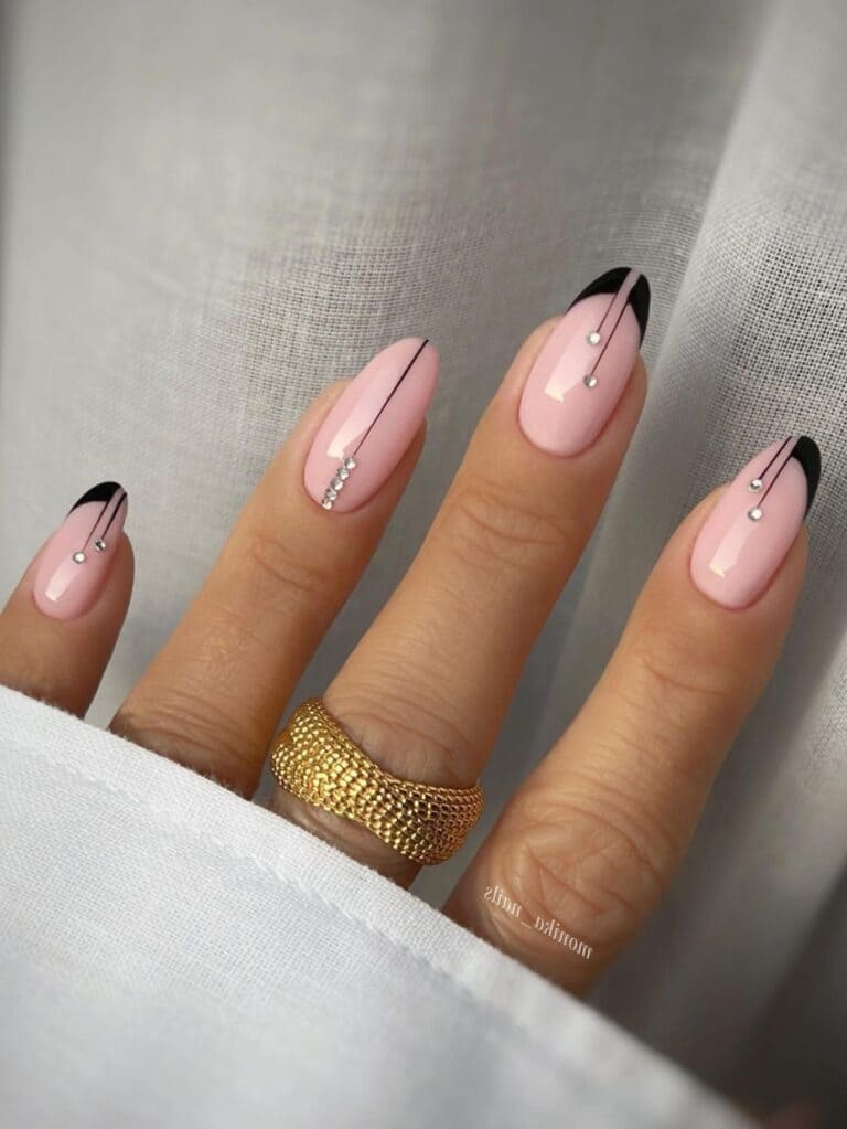 Black French manicure with geometric lines and gems