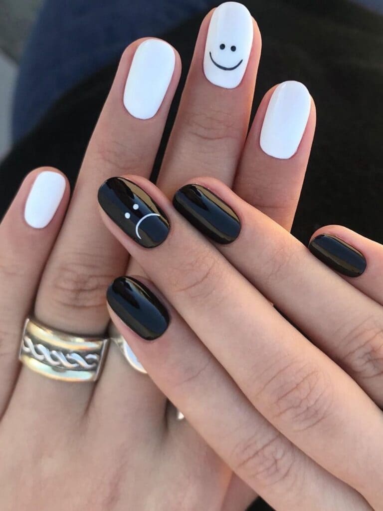 Black and white nails with face expression emojis