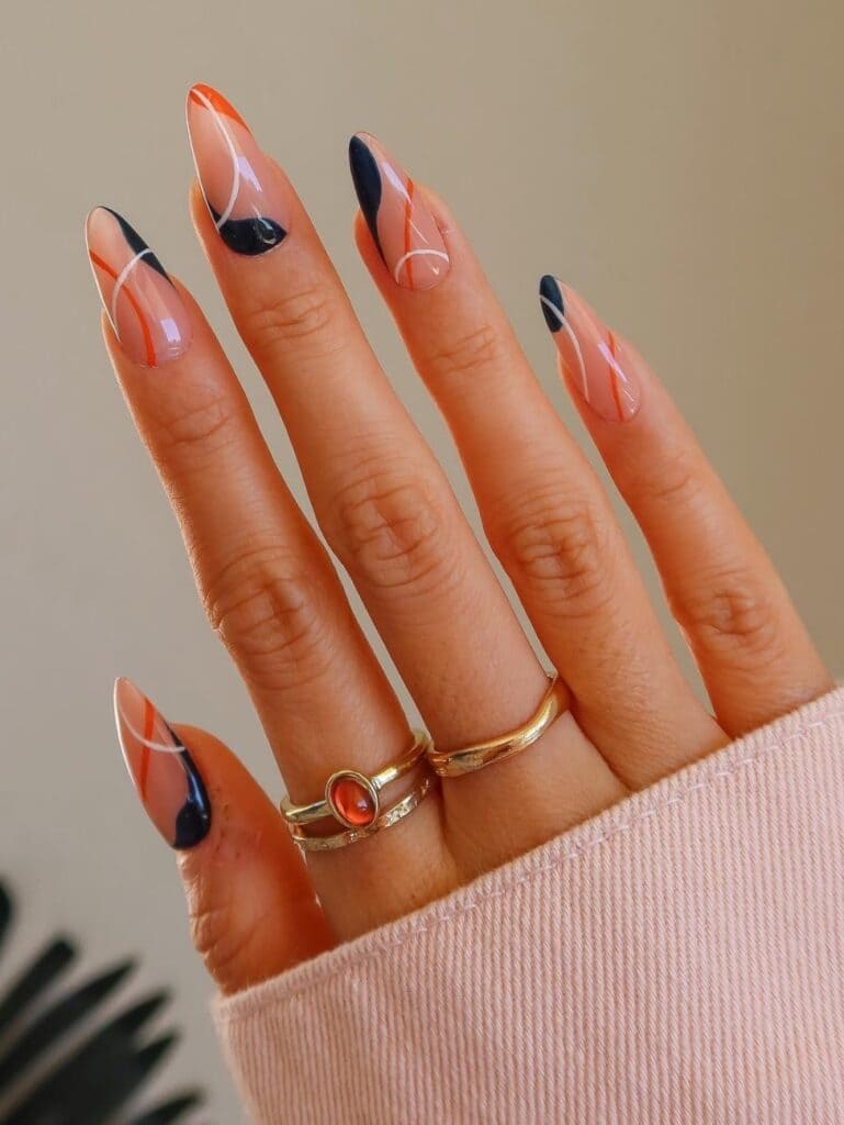 Orange and black swirl nail design
