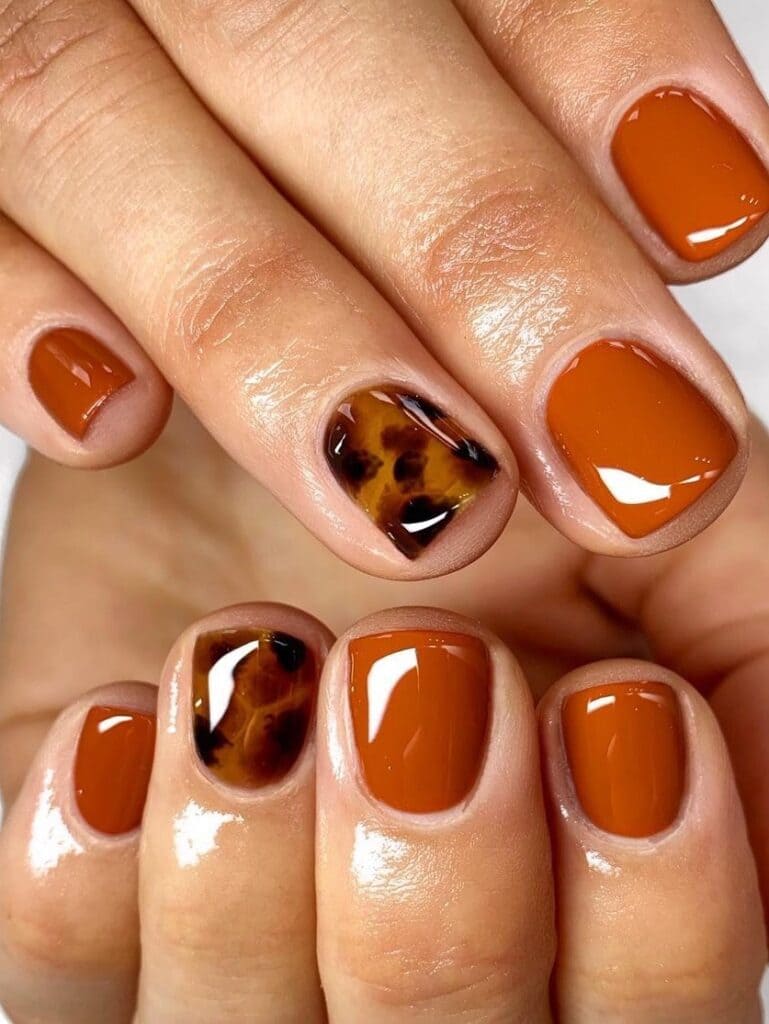 Short burnt orange and tortoise nails
