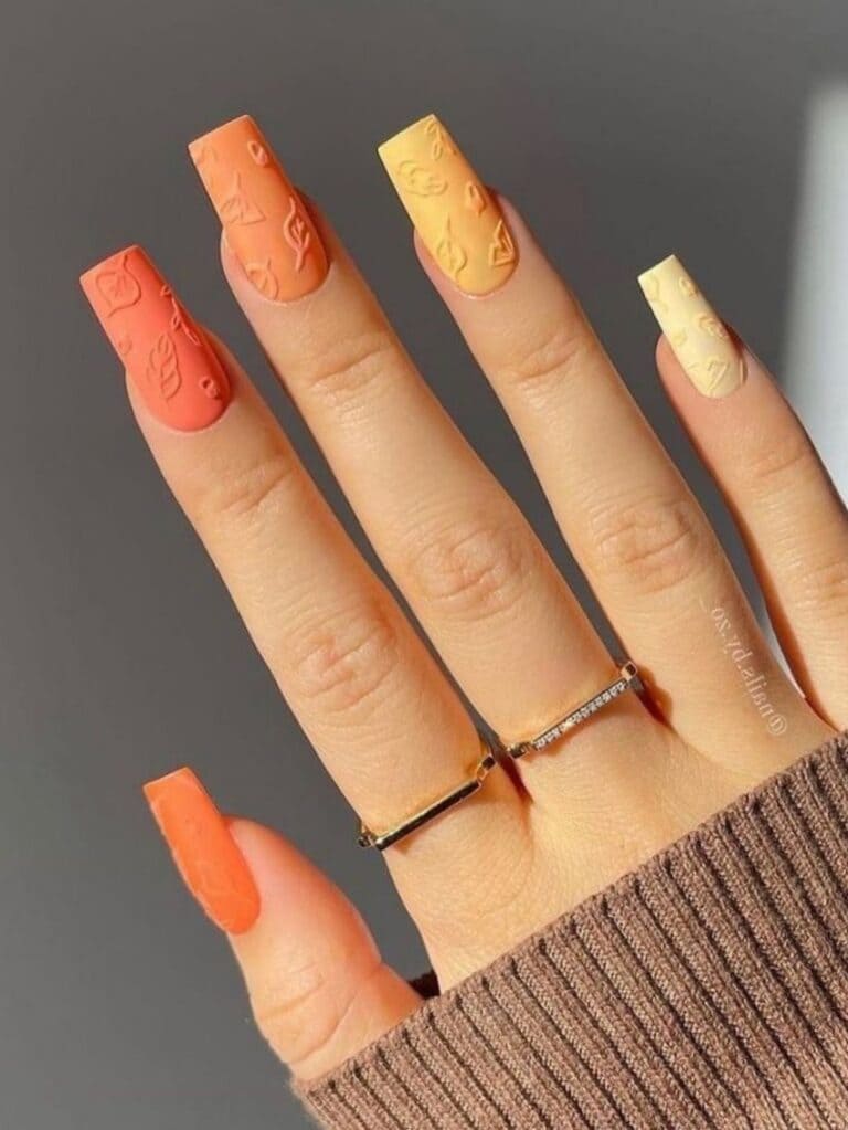 Vertical ombre nails in orange shades with 3D leaves