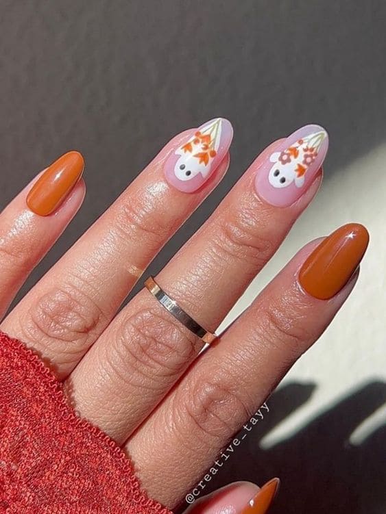 Burnt orange and ghost nail design