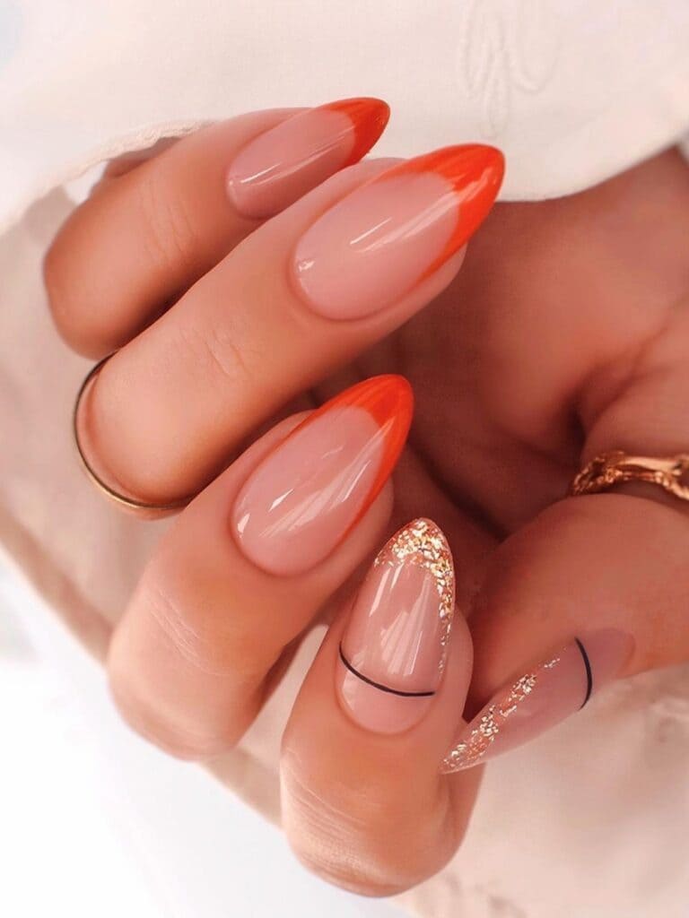 Almond-shaped burnt orange and gold French manicure