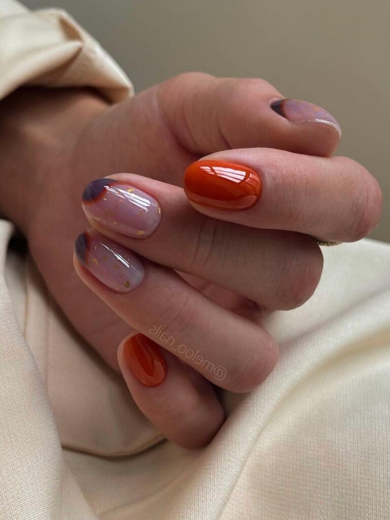 Dark orange short nails with purple swirls