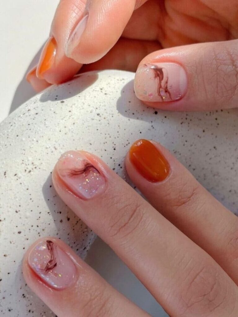 Short burnt orange and marble nails