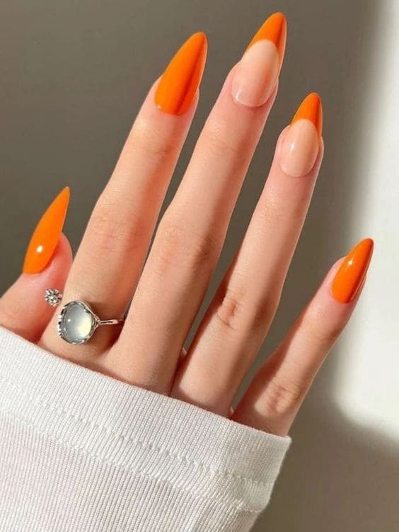 Stiletto-shaped orange French manicure