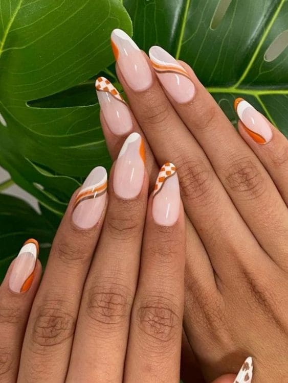 Burnt orange and white swirls on milky nails