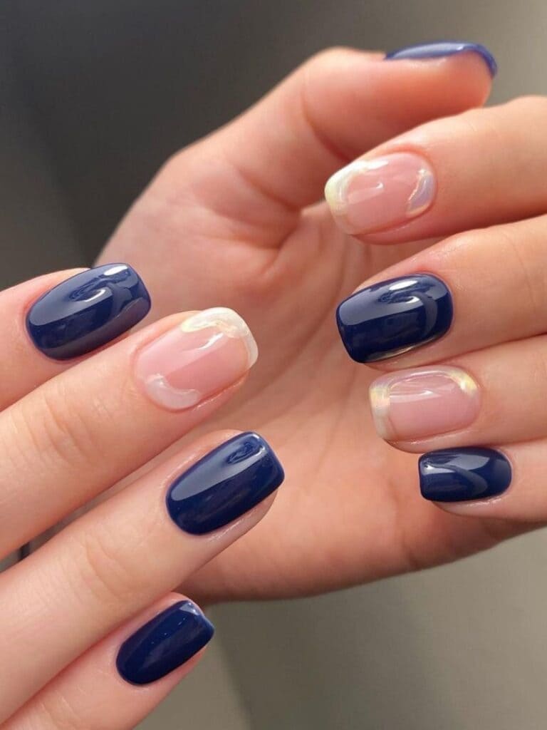 Short navy nails with negative-space pearl