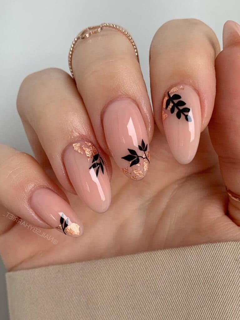 Almond-shaped nude nails with fall leaf designs