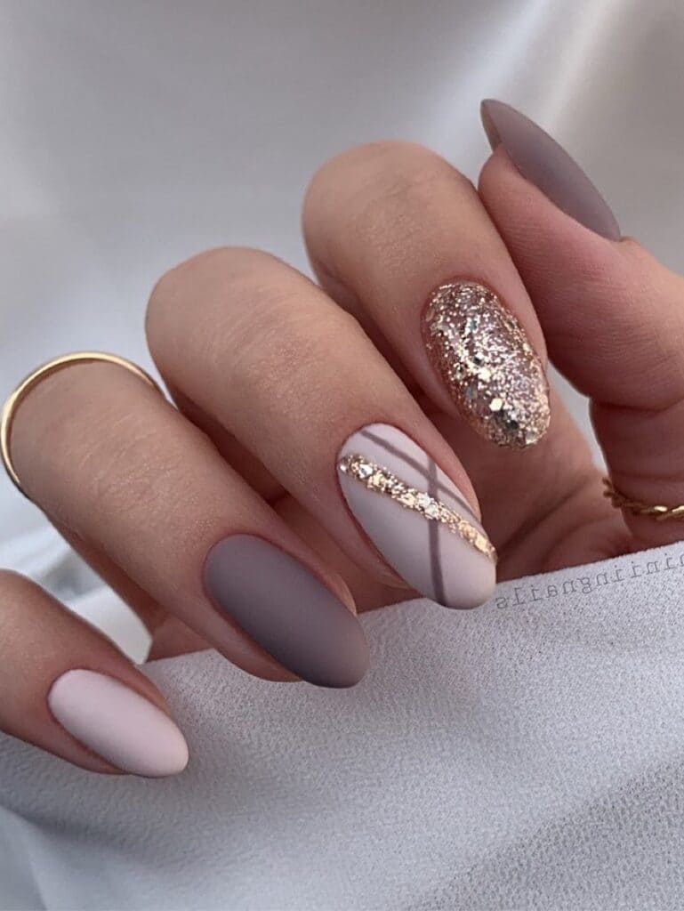 Mauve and gold glitter fall nails with geometric line designs