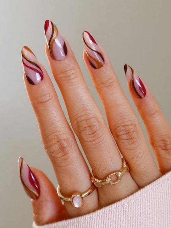 Brown, burgundy, and gold swirl fall nail designs