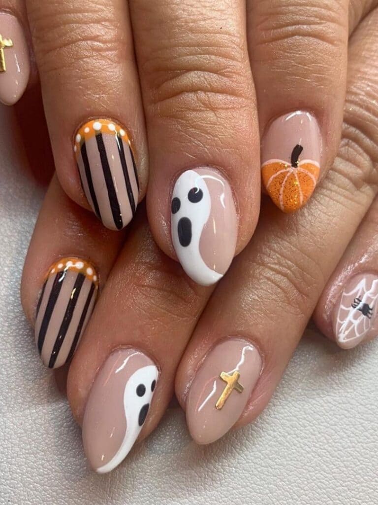 Short nude nails with mix-and-match Halloween design