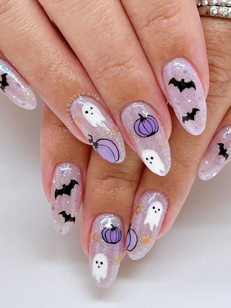 Shimmery silver nails with purple pumpkins, black bats, and ghosts