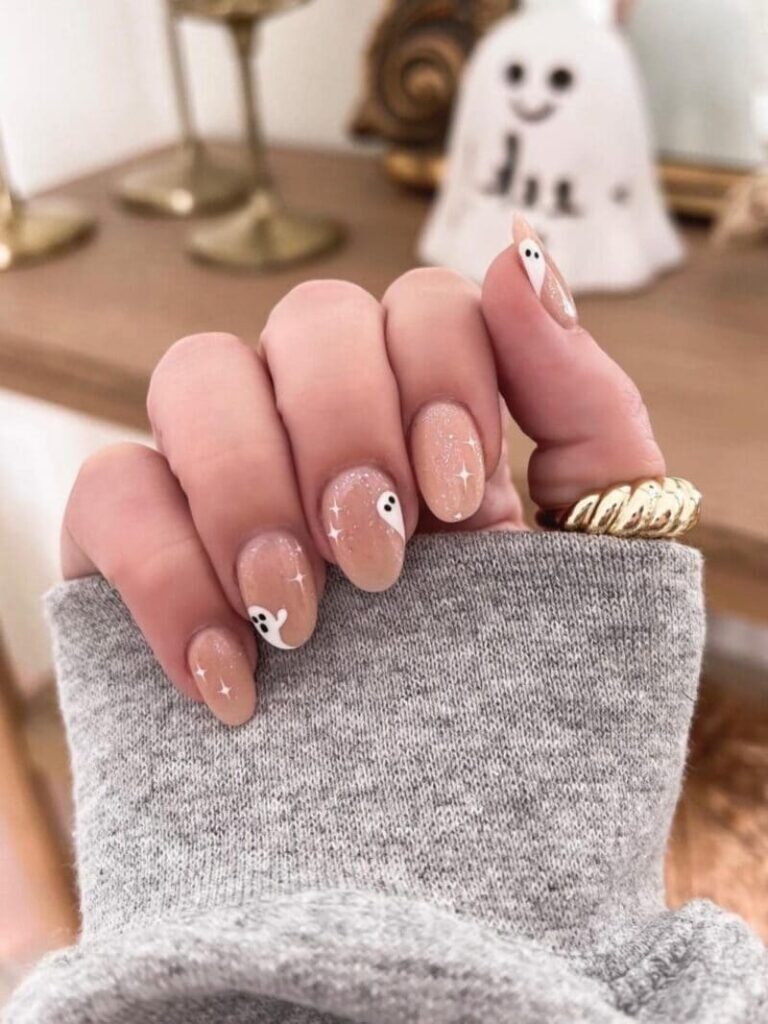 Short shimmery nude nails with a ghost accent 