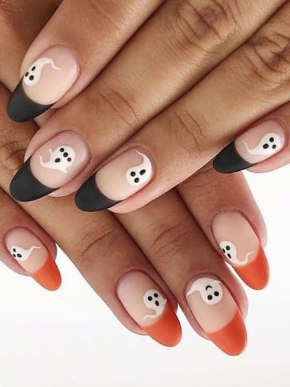 Matte black and orange French tip nails with ghosts