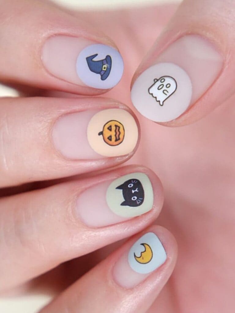 Various pastel half-dip nails with Halloween elements