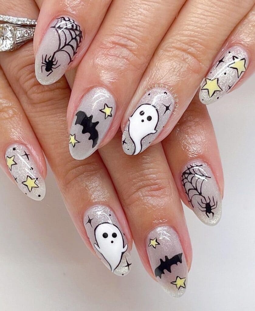 Shimmery silver nails with Halloween elements