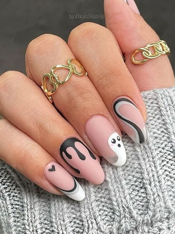 Nude acrylic nails with black and white Halloween design