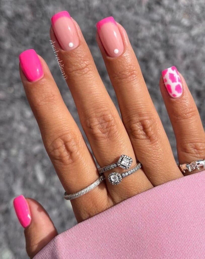 Hot pink nails with French tips and cow print