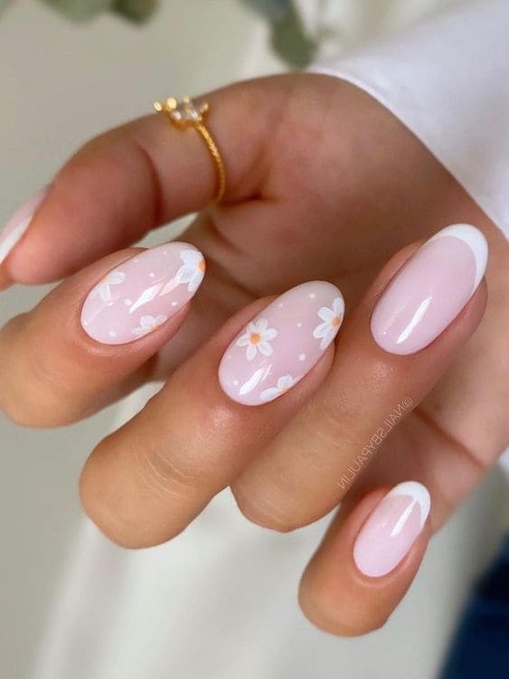 Oval-shaped, light pink and white French-tip nails with flowers