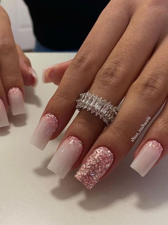 White acrylic nails with pink glitter ombre