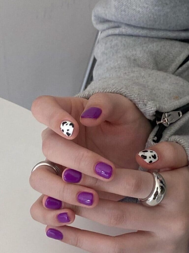 Short purple nails with cow print 