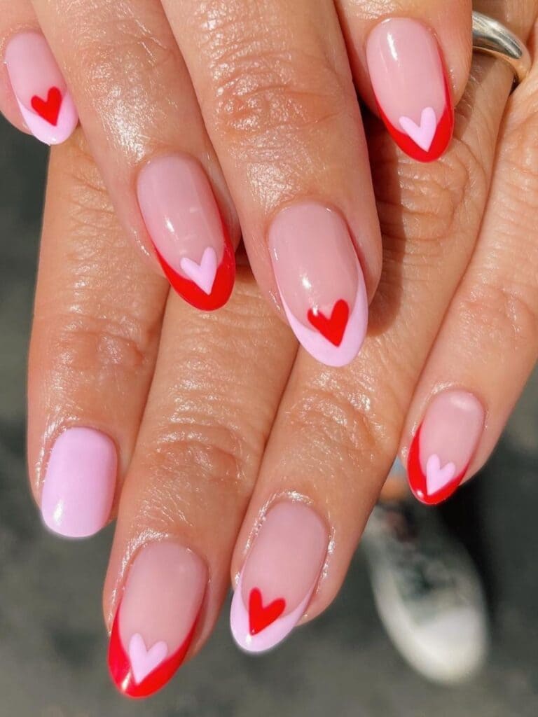 Short pink and red French manicure with a heart accent 