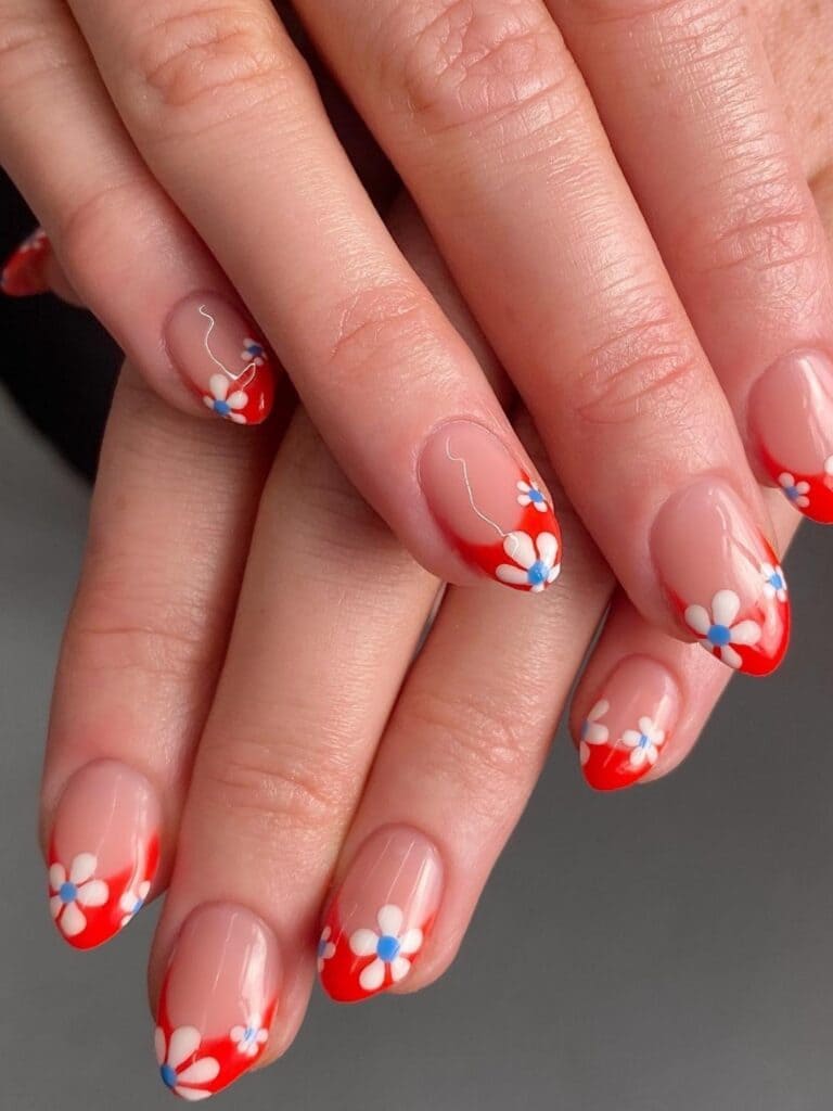 Short, red French tips with flowers