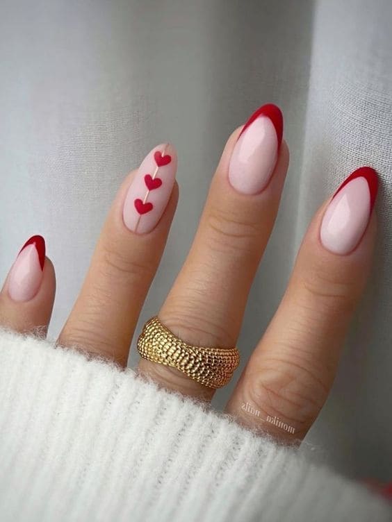 Red French manicure with geometric heart accent