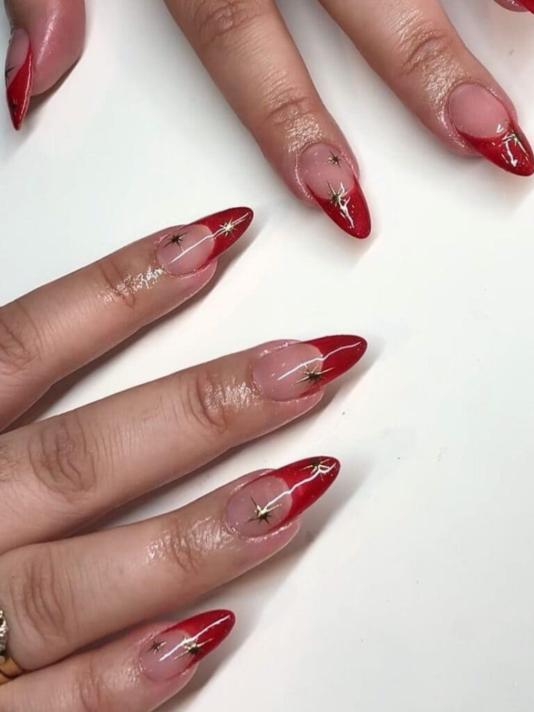 Red French tips with golden sparkles