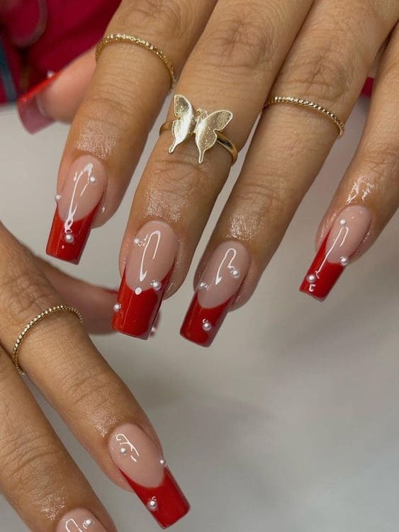 Coffin-shaped, red French-tip nails with pearls