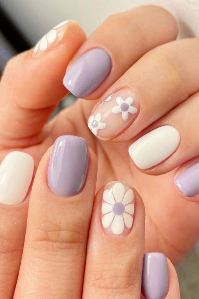 Light purple and white manicure with floral accent