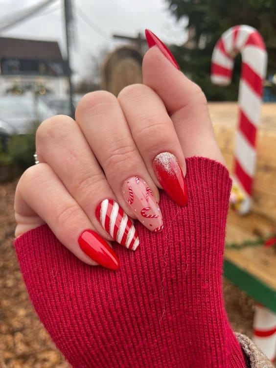 Red almond-shaped nails with candy canes and stripes