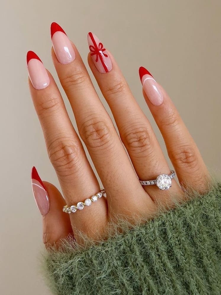 Almond-shaped, red French tips with a Christmas gift 