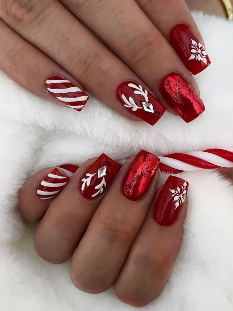 Red and white nails with reindeer and stripes 