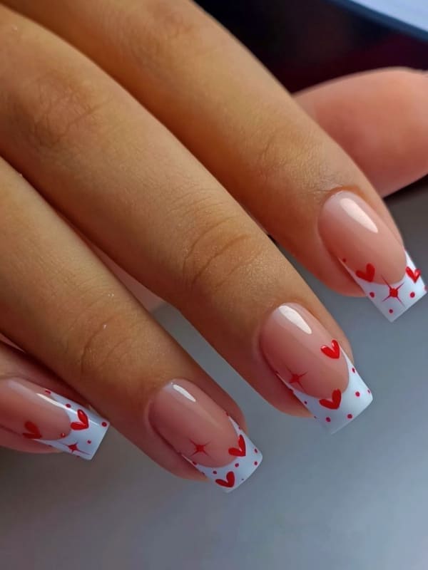 white acrylic French tips with red hearts 