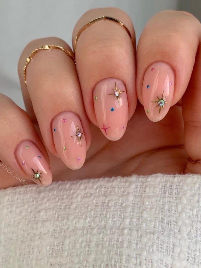short, nude nails with sparkles 