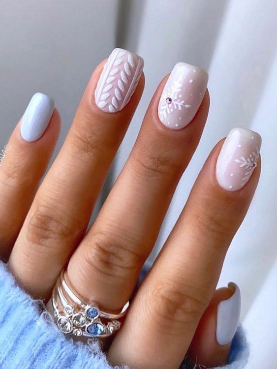Milky white and light blue nails with snowflakes
