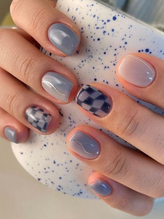 Gray-blue nails with a checkerboard accent