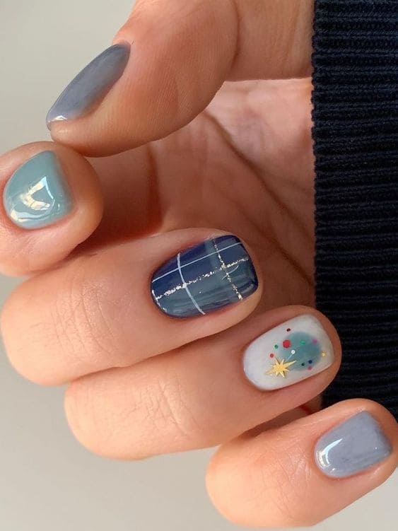 Various shades of blue short nails with winter designs