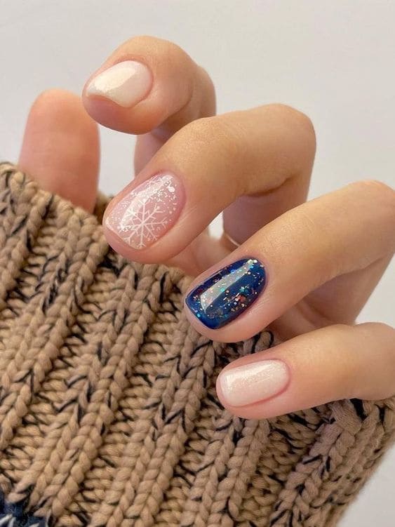 Winter Korean nail designs with a dark blue accent