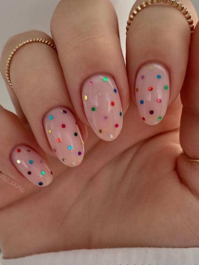 Festive winter nail designs with colorful polka dots