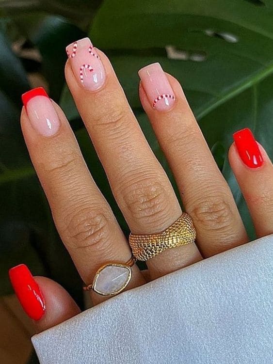 red nails with candy cane  design 